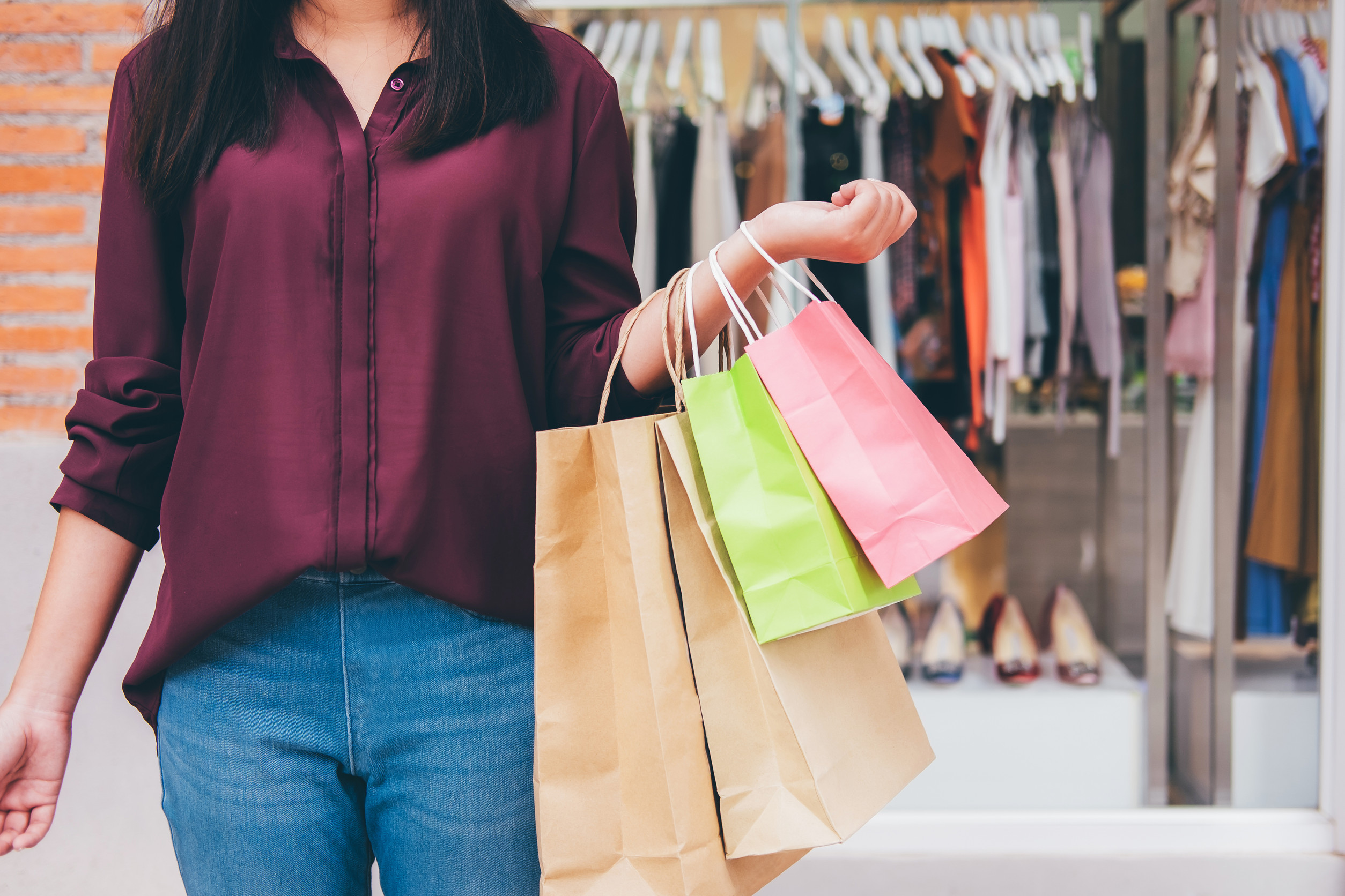 A Young Woman Holding Colourful Shopping Bags