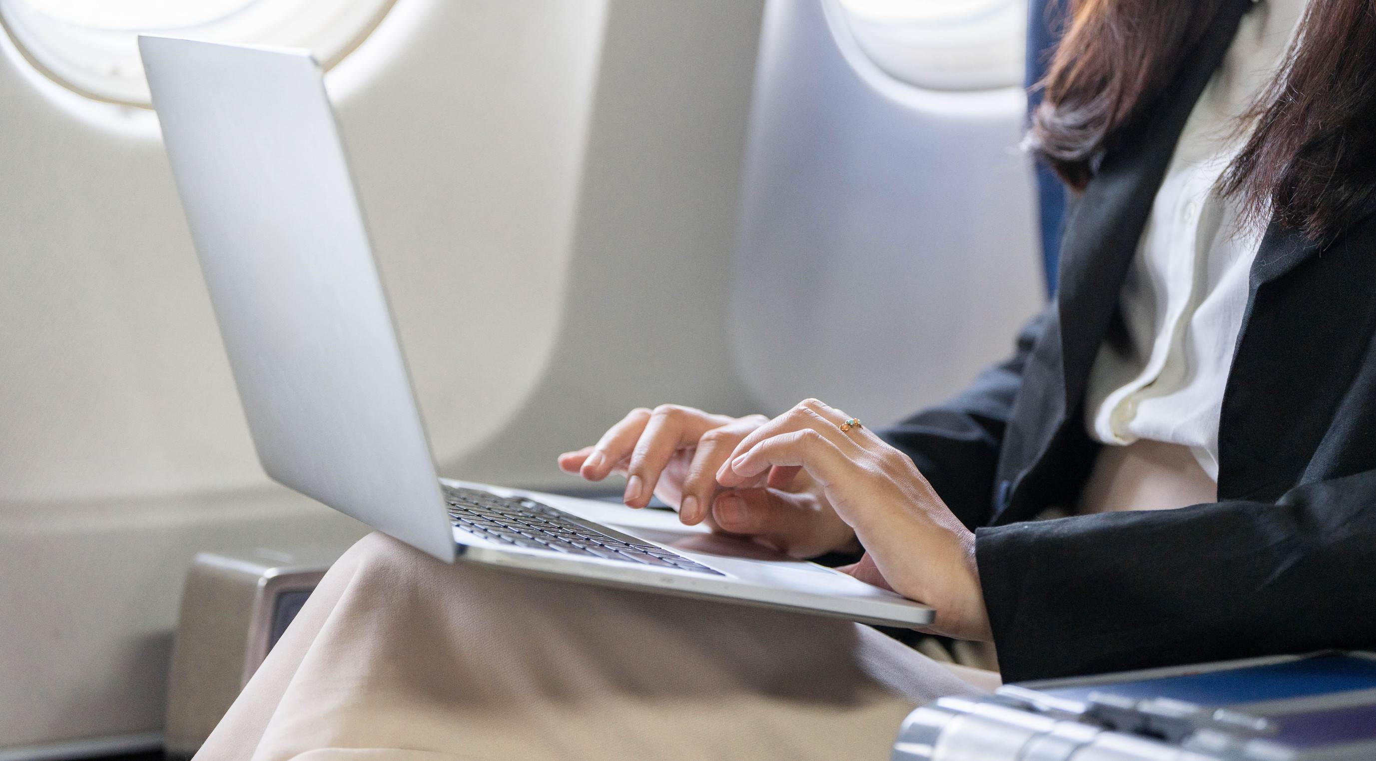 Business Woman Working in Plane